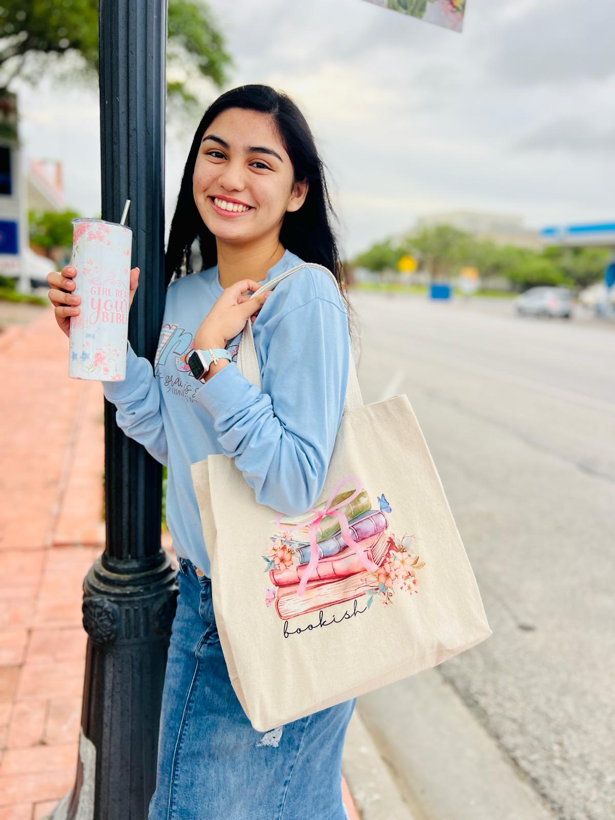 "Bookish" is our 100% Cotton twill Tote Bag in a natural color and a graphic of stacked books