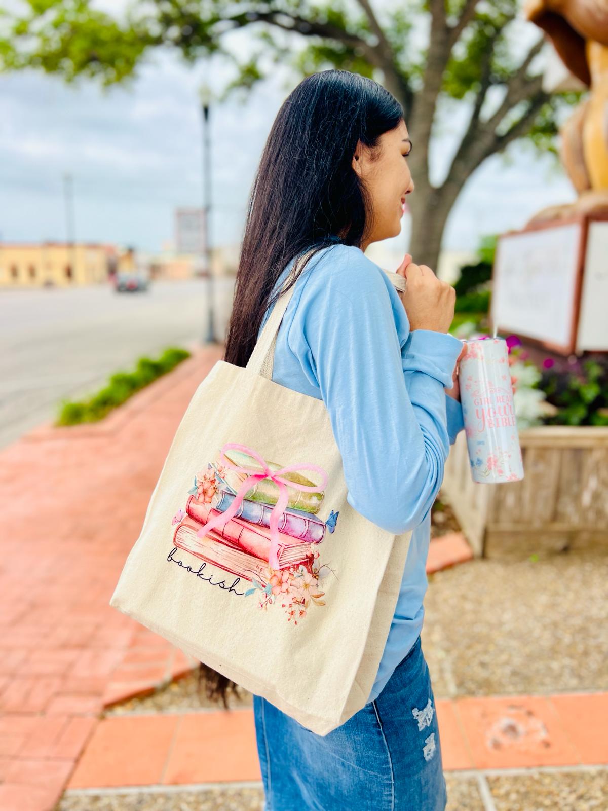 "Bookish" is our 100% Cotton twill Tote Bag in a natural color and a graphic of stacked books